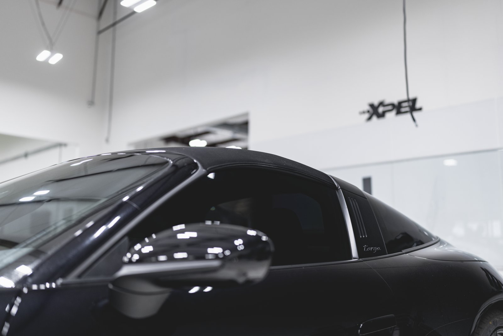 Porsche 911 Targa with tinted windows under XPEL sign